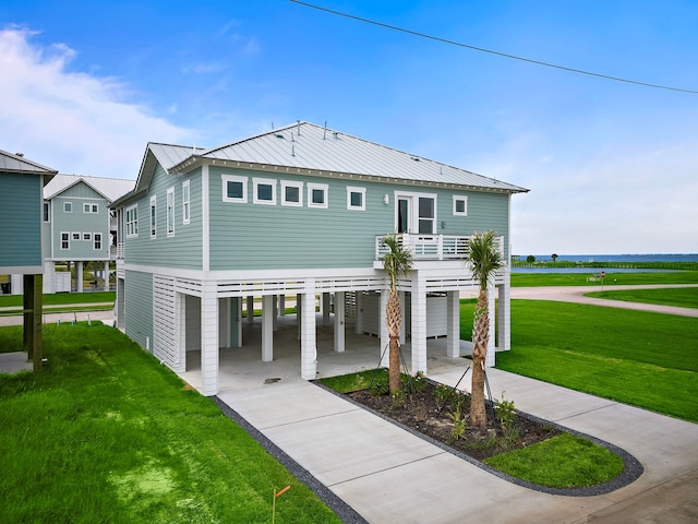 rear view of house featuring a yard and a carport