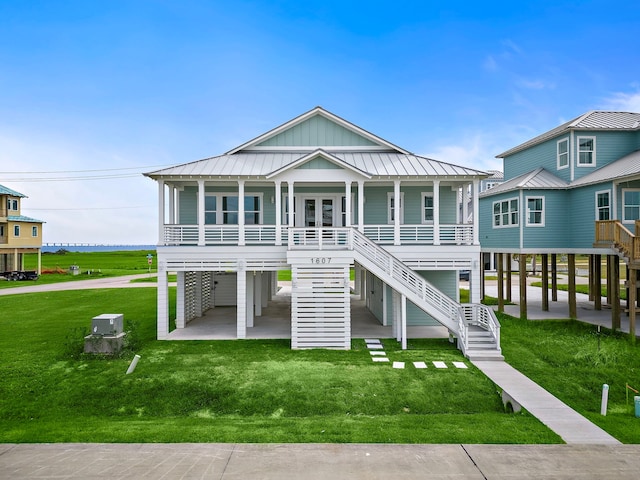 view of front of home with a front yard, a carport, and a porch