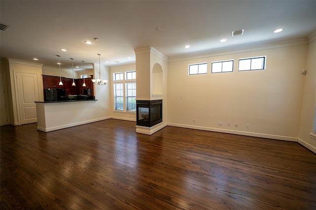 unfurnished living room featuring an inviting chandelier, a multi sided fireplace, dark hardwood / wood-style flooring, and crown molding