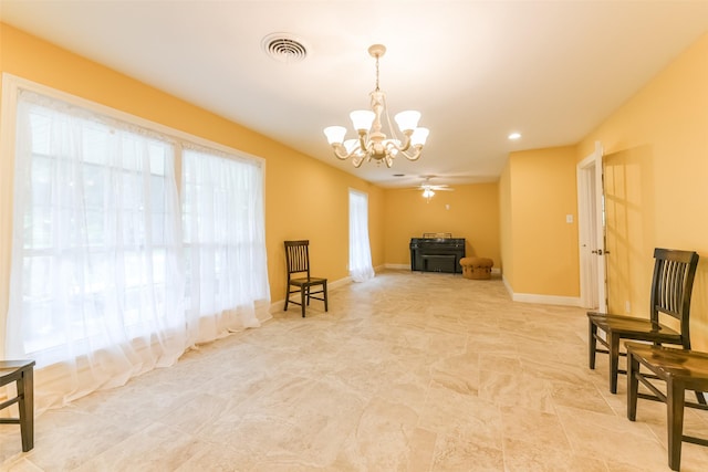 sitting room featuring ceiling fan with notable chandelier