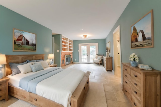 bedroom featuring french doors, light tile patterned flooring, and access to outside