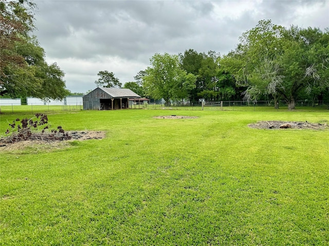 view of yard with an outdoor structure and a rural view