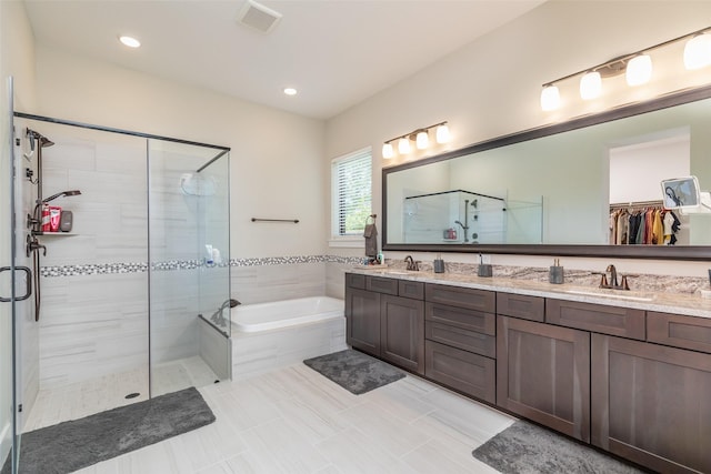 bathroom with vanity, tile patterned floors, and plus walk in shower