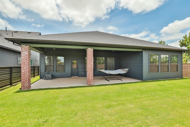 back of house featuring a patio area and a lawn