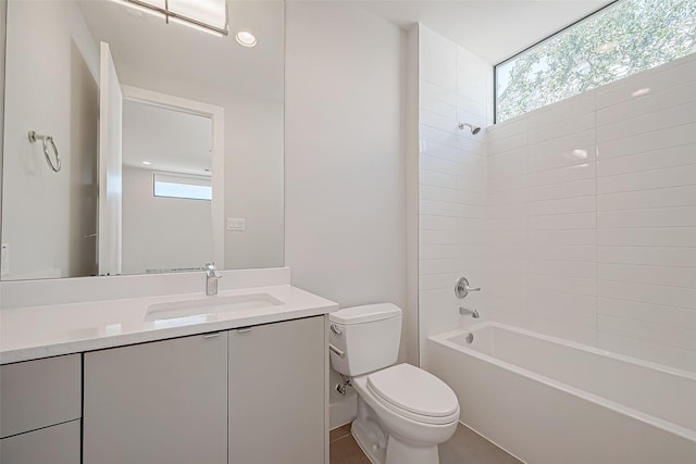 full bathroom featuring tiled shower / bath combo, vanity, a healthy amount of sunlight, and toilet