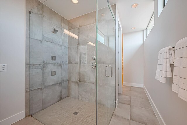 bathroom featuring tile patterned floors and a shower with shower door