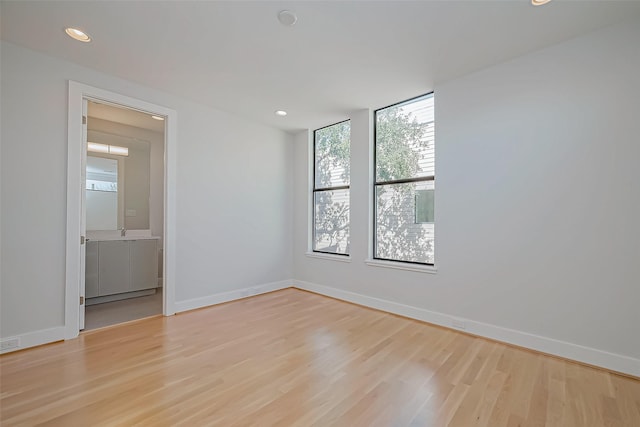 spare room featuring light hardwood / wood-style flooring