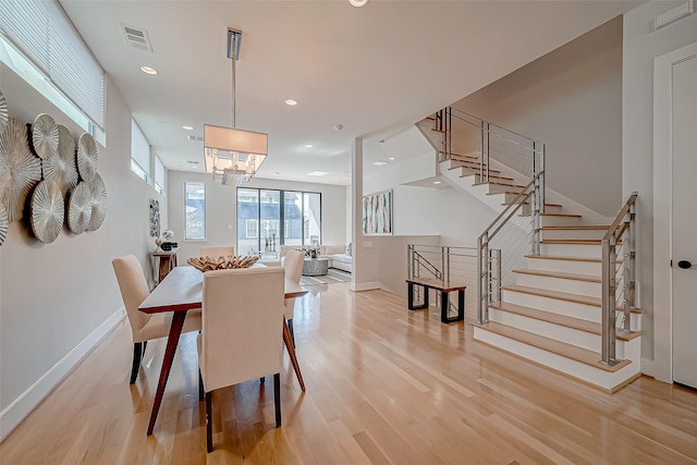 dining space with light hardwood / wood-style floors