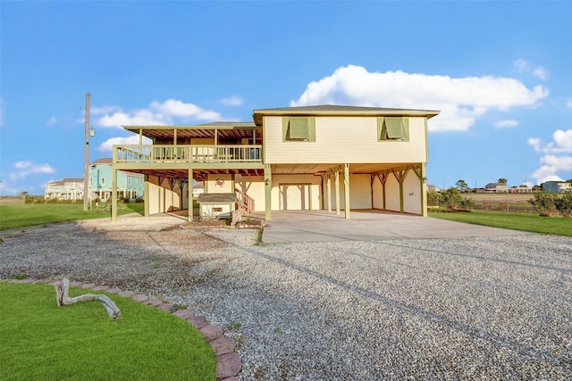 back of property featuring a carport, a wooden deck, and a yard