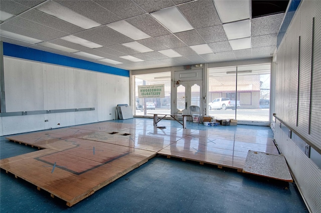 interior space featuring a drop ceiling and french doors