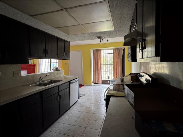 kitchen featuring extractor fan, sink, light tile patterned floors, stainless steel dishwasher, and decorative backsplash