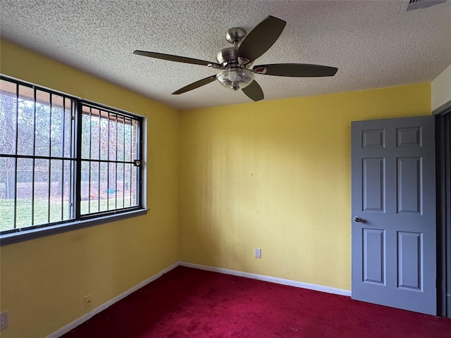 spare room with carpet flooring and a textured ceiling