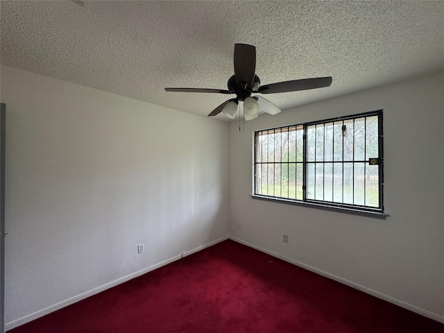 carpeted empty room with a textured ceiling