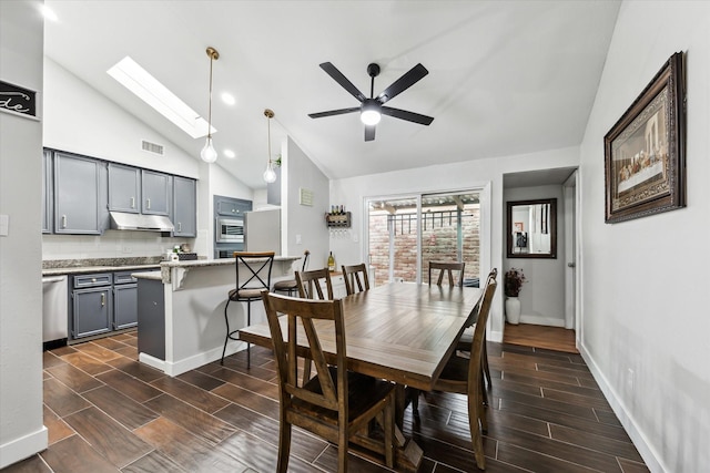 dining area with lofted ceiling with skylight and ceiling fan