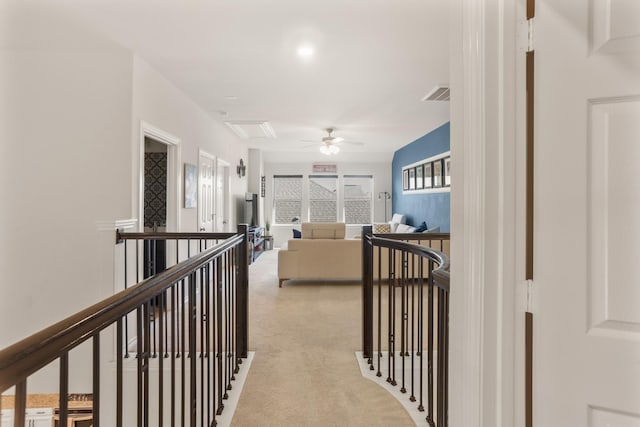 hallway with light colored carpet