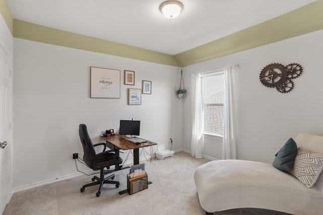 home office featuring light colored carpet and vaulted ceiling