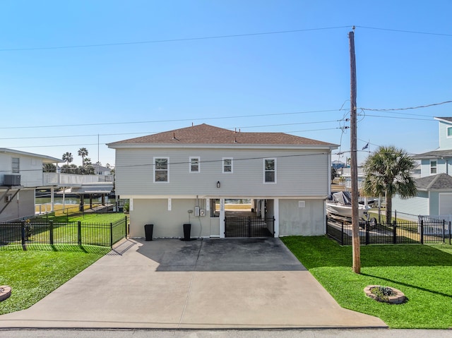 back of house with a carport, a lawn, and central air condition unit