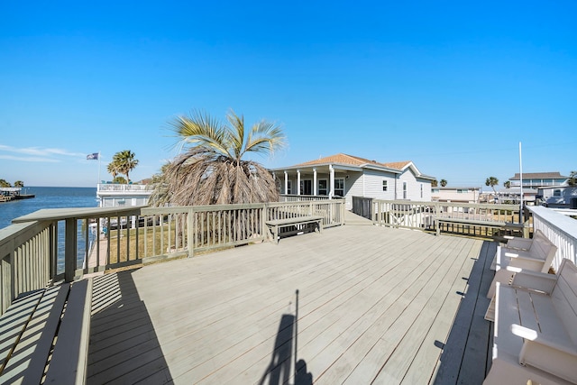 wooden terrace featuring a water view