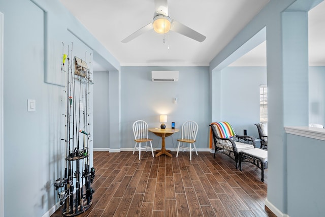 sitting room with a wall mounted air conditioner and ceiling fan