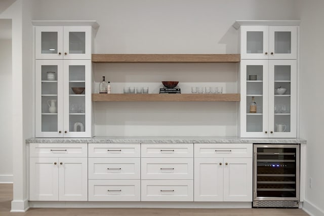 bar with wine cooler and white cabinets