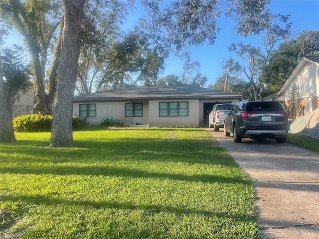 ranch-style house with a garage and a front yard