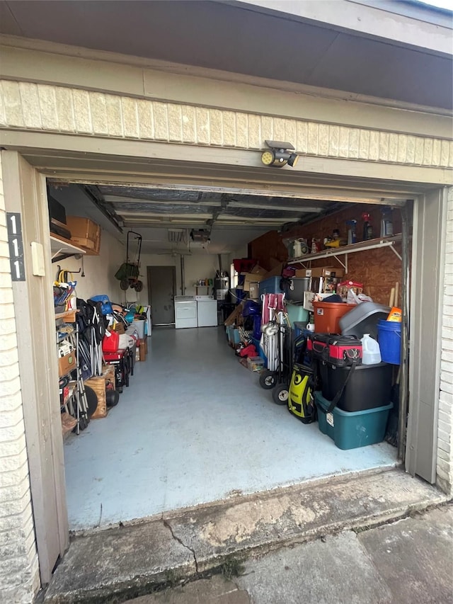 garage featuring a garage door opener and independent washer and dryer