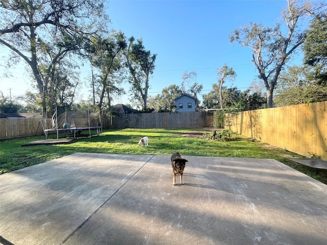 view of patio / terrace with a trampoline and a fenced backyard