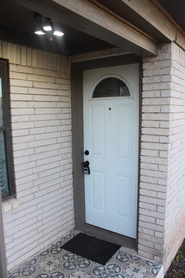 entrance to property with brick siding