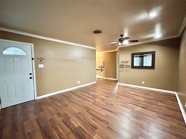 entrance foyer featuring baseboards, ornamental molding, and wood finished floors