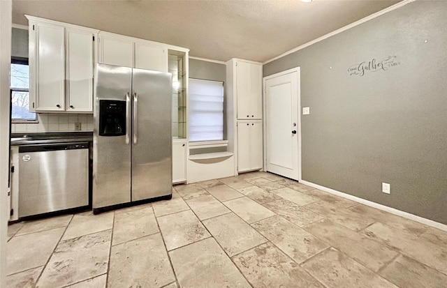 kitchen with crown molding, stainless steel appliances, tasteful backsplash, white cabinets, and baseboards