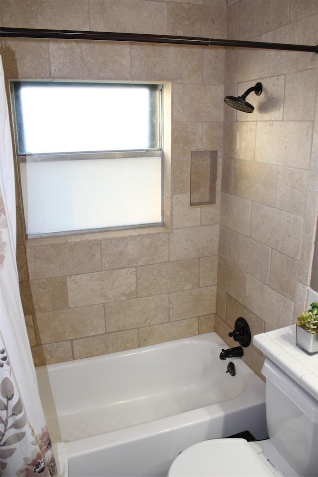 full bathroom with shower / bath combo and toilet