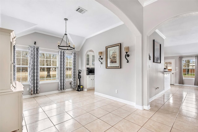19475 Humaya, Porter, TX 77365 - unfurnished dining area featuring light tile patterned flooring, crown molding, arched walkways, a chandelier, and lofted ceiling