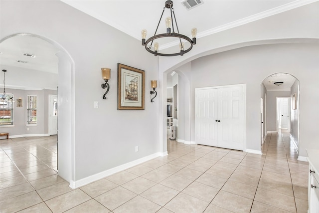 19475 Humaya, Porter, TX 77365 - unfurnished dining area with a chandelier, light tile patterned floors, ornamental molding, baseboards, and arched walkways
