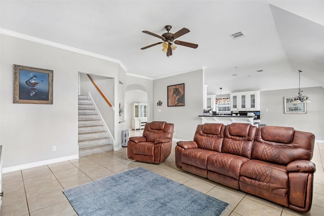 19475 Humaya, Porter, TX 77365 - living area featuring ceiling fan, arched walkways, stairway, light tile patterned flooring, and crown molding