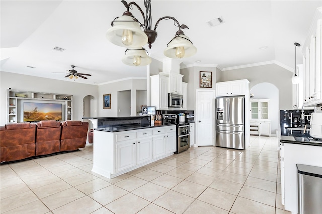 19475 Humaya, Porter, TX 77365 - kitchen featuring stainless steel appliances, arched walkways, dark countertops, light tile patterned flooring, and crown molding