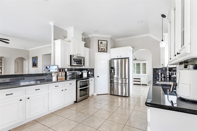 19475 Humaya, Porter, TX 77365 - kitchen with appliances with stainless steel finishes, arched walkways, ornamental molding, tasteful backsplash, and white cabinets
