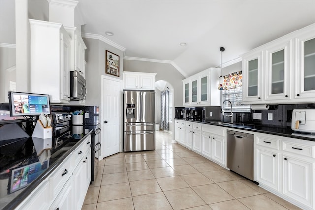 19475 Humaya, Porter, TX 77365 - kitchen with stainless steel appliances, a sink, arched walkways, decorative backsplash, and vaulted ceiling