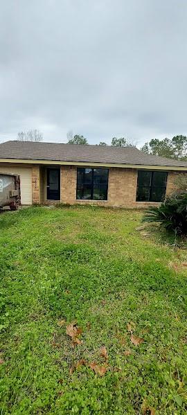 back of property featuring a lawn