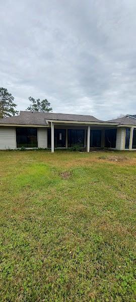 rear view of house with a yard