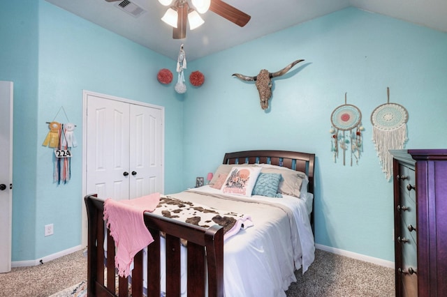 carpeted bedroom featuring lofted ceiling, a closet, visible vents, and baseboards