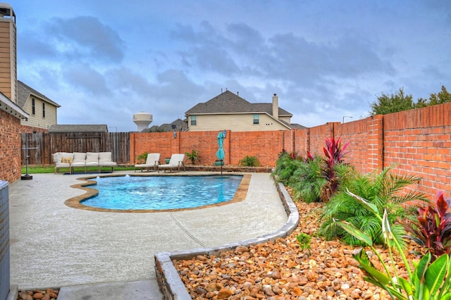 view of pool featuring a patio area, a fenced backyard, an outdoor living space, and a fenced in pool