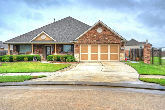 view of front of house with a garage and a front lawn