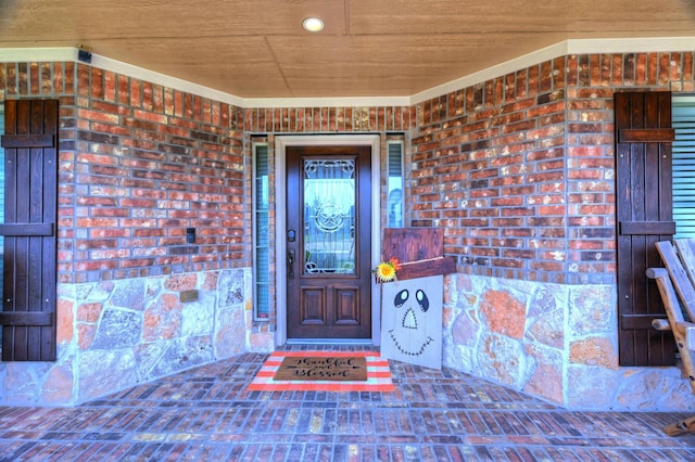 entrance to property featuring brick siding