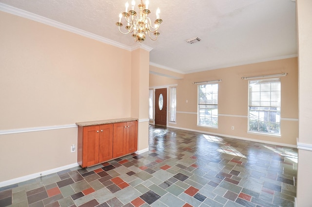 entrance foyer featuring ornamental molding, a notable chandelier, and a textured ceiling