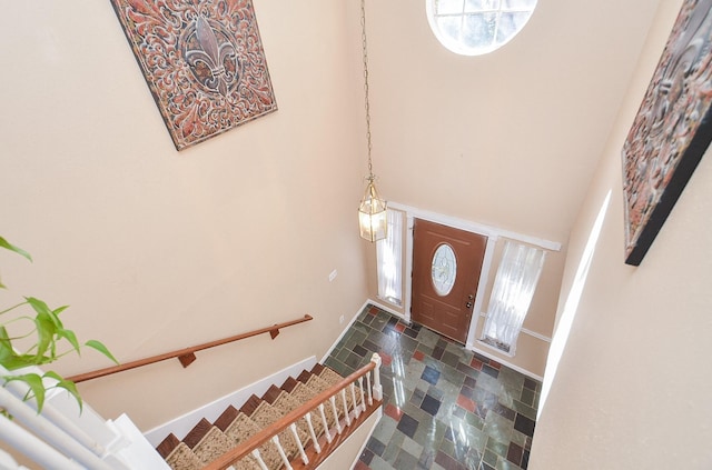 entryway with a towering ceiling