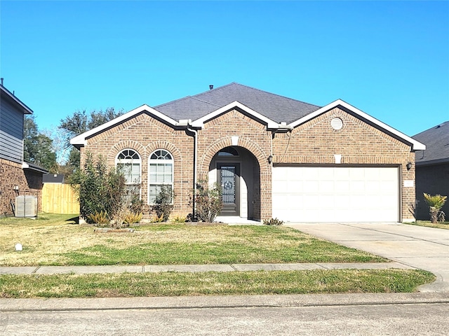 view of front of property with a garage, cooling unit, and a front lawn