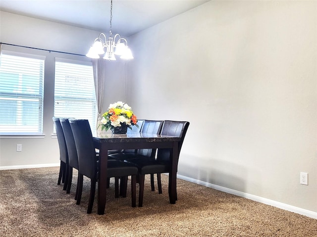 carpeted dining space featuring an inviting chandelier