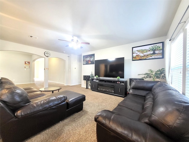 carpeted living room featuring ceiling fan