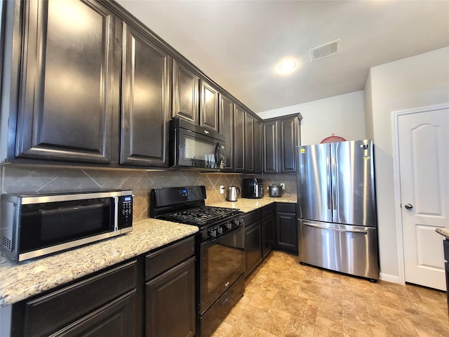 kitchen featuring dark brown cabinets, backsplash, light stone counters, and black appliances