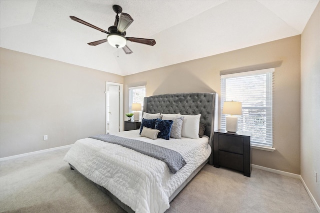 bedroom featuring ceiling fan, light colored carpet, and vaulted ceiling